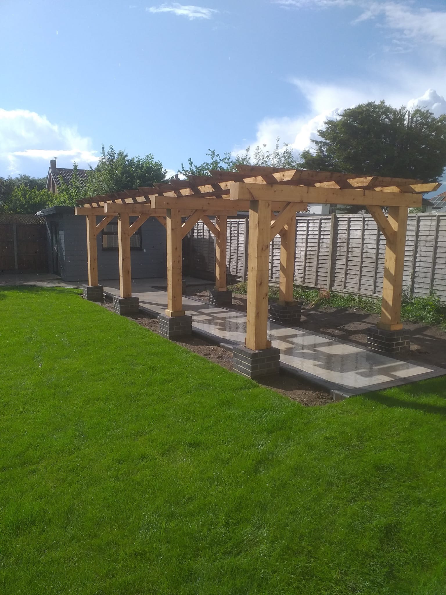 Landscaped garden with pergola and stone paving